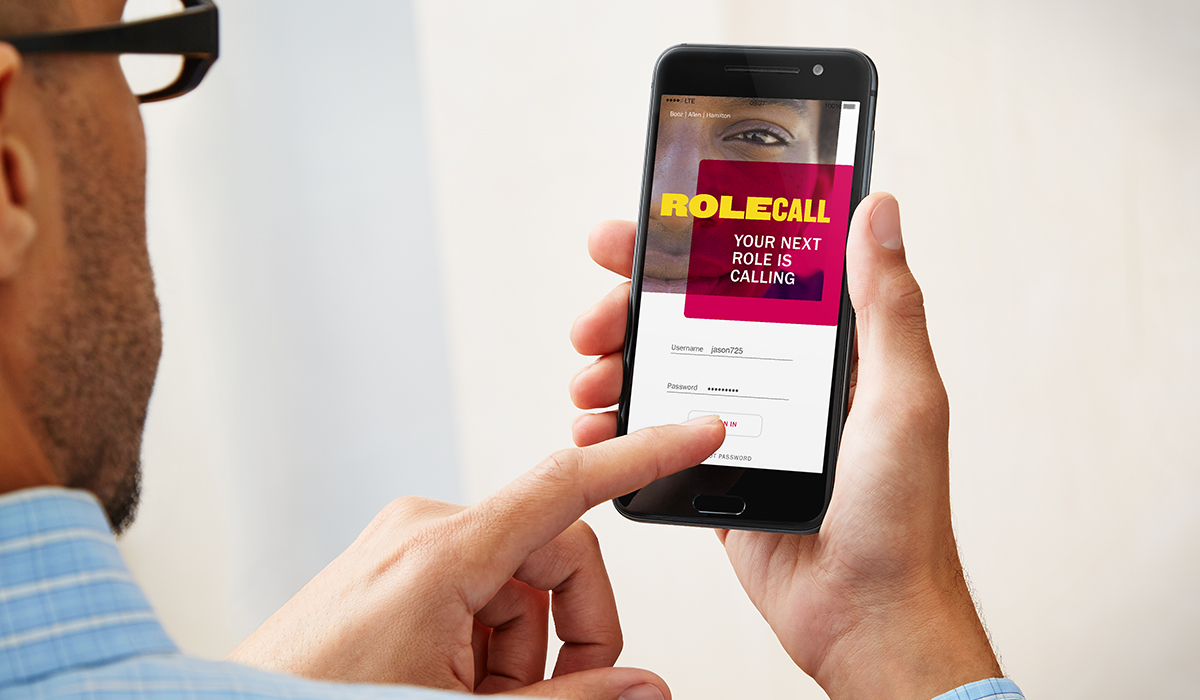 Man holding phone with RoleCall app displayed